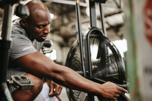 man fixing gym equipment